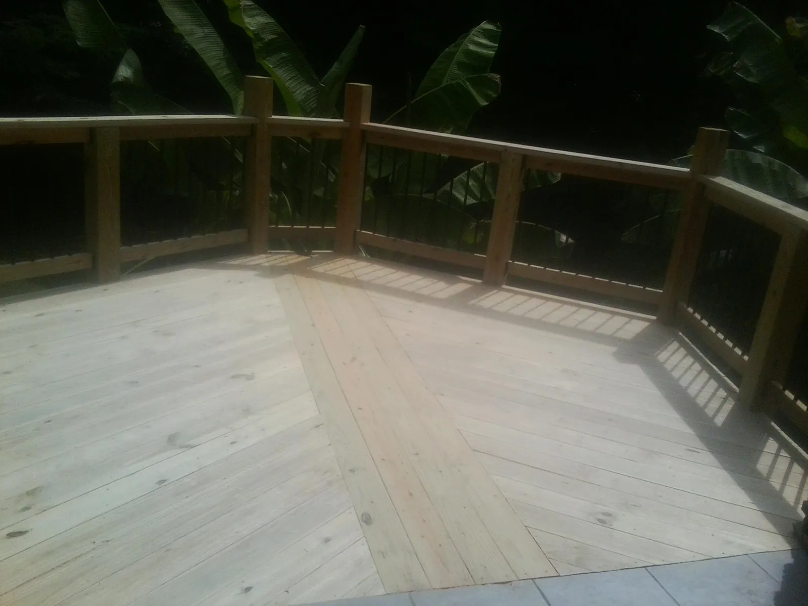 New wood deck and railing built off the back of a home in Sandy Creek